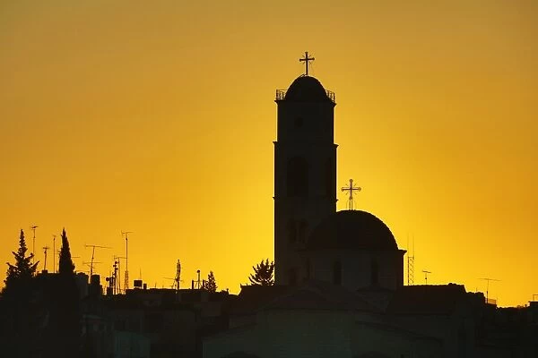 Silhouette of the Greek Orthodox Church dome and tower at sunset in Amman, Jordan