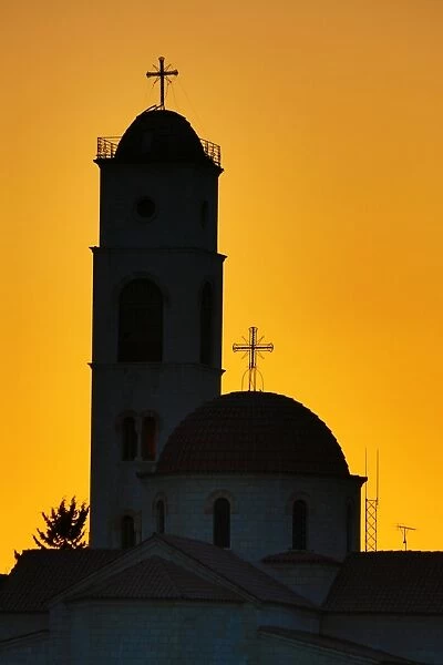 Silhouette of the Greek Orthodox Church dome and tower at sunset in Amman, Jordan