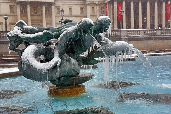 Snow and ice on frozen fountains in Trafalgar Square, London