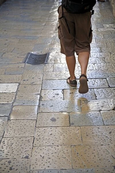 Split, Croatia. Legs of walking man at Diocletians Palace, Split, Croatia