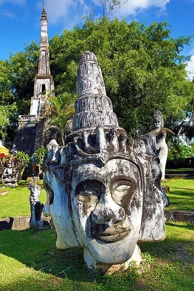 Statues of Buddha heads and faces at the Buddha Park, Vientiane, Laos