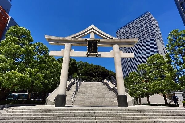 Stone Torii gate and office buildings outside the Hie-Jinja Shinto Shrine, Tokyo, Japan