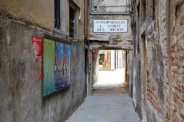 Street scene of a sortoportego tunnel under buildings in Venice, Italy