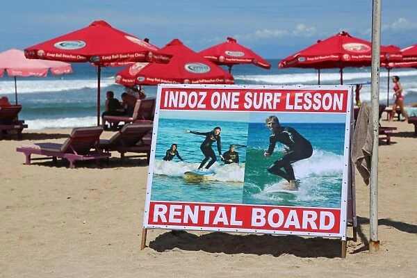Surf lesson and board rental sign, tourist activities on Legian Beach, Denpasar, Bali, Indonesia