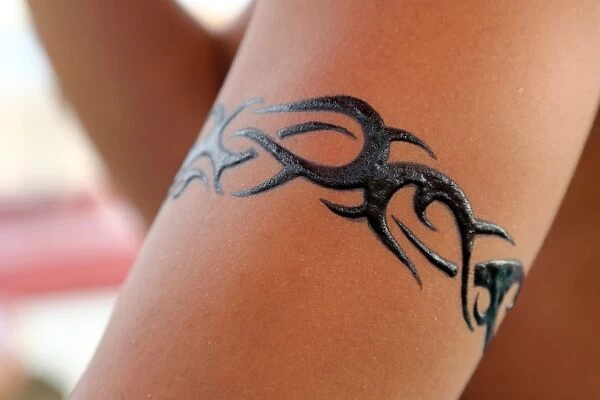 Tattoos for tourists. Temporary henna tattoo being applied, Legian Beach, Denpasar, Bali, Indonesia