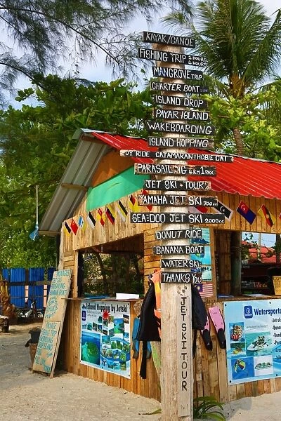 Tourist activities signs and hut on the beach in Pantai Cenang, Langkawi, Malaysia
