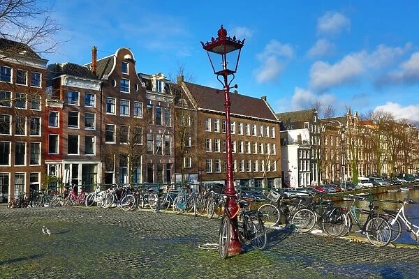 Traditional houses and a bridge over a canal on Herengracht in Amsterdam, Holland