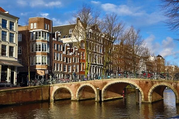 Traditional houses and a bridge over a canal on Herengracht in Amsterdam, Holland