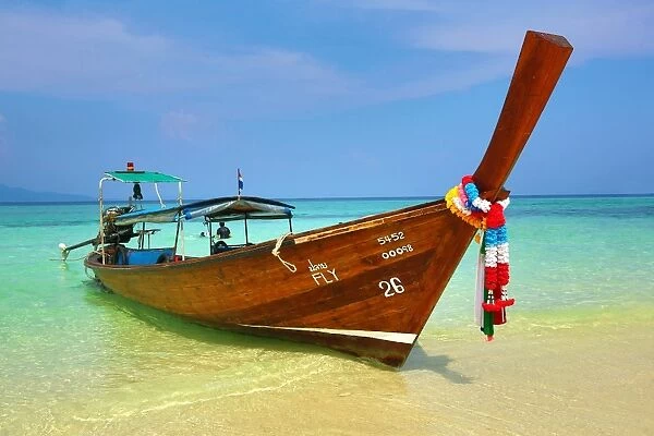 Traditional Thai long tailed boats on Ko Phi Phi Don island beach in Thailand