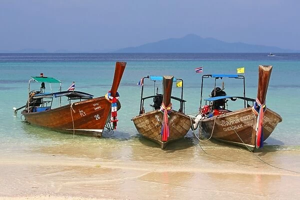 Traditional Thai long tailed boats on Ko Phi Phi Don island beach in Thailand