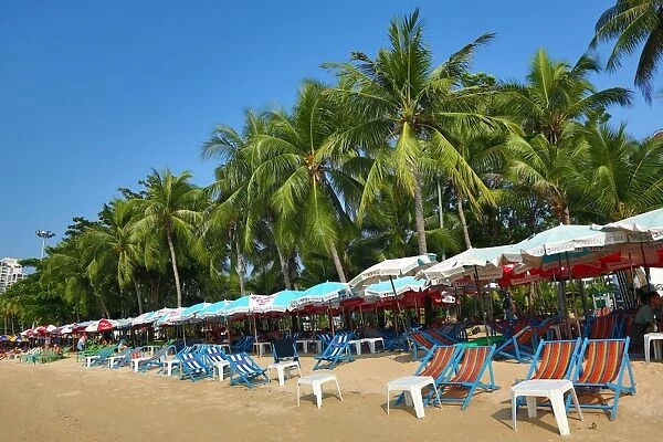 Tropical beach scene with umbrellas on the seafront of Pattaya, Thailand