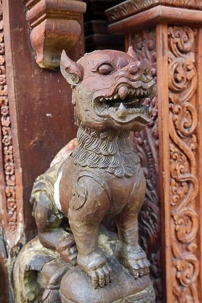 Wooden carving on the Sanctuary of Truth Temple, Prasat Sut Ja-Tum, Pattaya, Thailand showing a wood statue of a dog