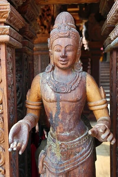 Wooden carving on the Sanctuary of Truth Temple, Prasat Sut Ja-Tum, Pattaya, Thailand showing a wood statue