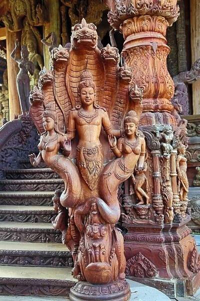 Wooden carving on the Sanctuary of Truth Temple, Prasat Sut Ja-Tum, Pattaya, Thailand showing a wood statue
