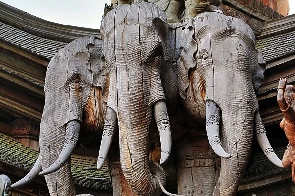 Wooden carving on the Sanctuary of Truth Temple, Prasat Sut Ja-Tum, Pattaya, Thailand showing a wood statue of elephants