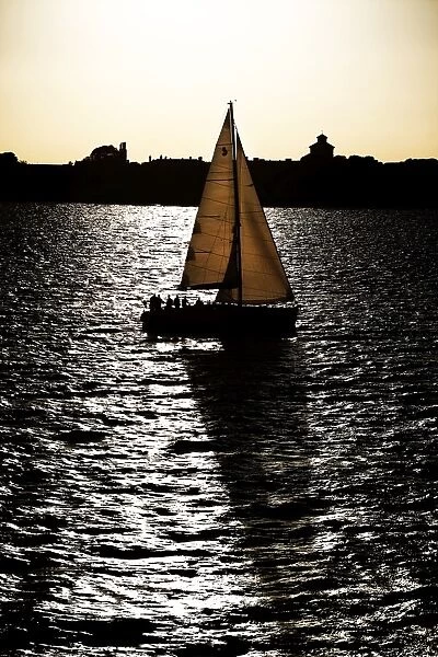 Yacht sailing on the sea at sunset
