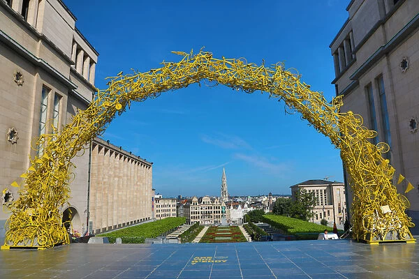 Yellow Arch of bicycles at the Mont des Arts Gardens and Tower of the Town Hall, Brussels