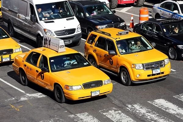 Yellow taxi cabs driving in the street, New York. America