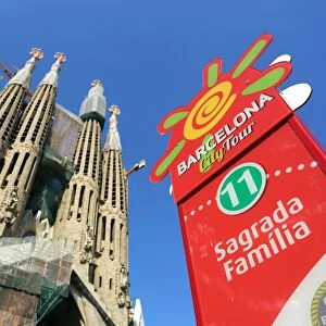 Barcelona City Tour bus stop sign for tourists at the Basilica de la Sagrada Familia cathedral in Barcelona, Spain