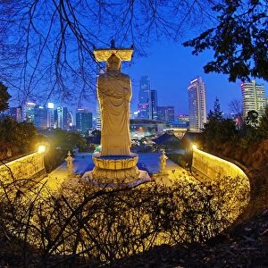 Buddha statue and city skyline, Bongeunsa Temple, Seoul, Korea