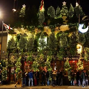Churchill Arms Pub covered in Christmas Trees in Kensington, London