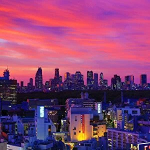 General view of the city skyline of Shinjuku at sunset seen from Shibuya, Tokyo, Japan