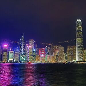 Lights of the city skyline of Central across Victoria Harbour at night in Hong Kong
