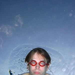 Man swimming underwater wearing goggles
