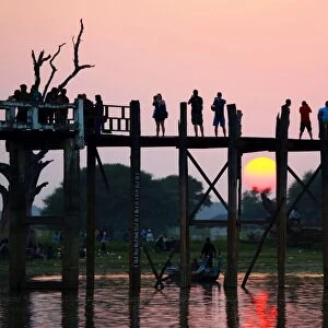 People crossing the U Bein Bridge at sunset, Amarapura, Myanmar