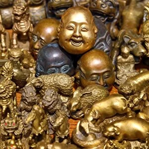 Pile of brass figures including laughing Buddha head in the Old City, Shanghai, China