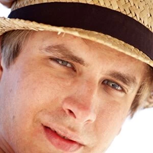 Portrait of a man on summer holiday wearing a straw hat