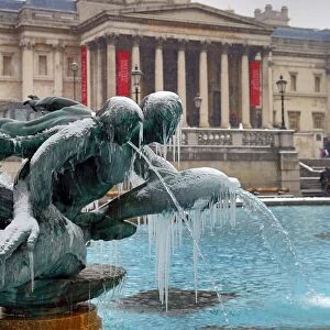 Snow and ice on frozen fountains in Trafalgar Square, London