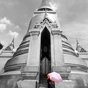 Spot colour pink umbrella at Phra Siratana Gold Chedi at Wat Phra Kaew, Bangkok, Thailand