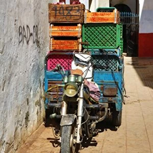 Street scene with a loaded motorcycle in the Medina of Rabat, Morocco