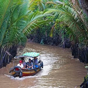 Tourist boat on canal on Con Lan (Unicorn) Island, near My Tho, Mekong Delta, Vietnam