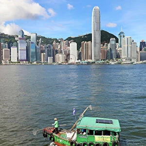 Traditional boat in Victoria Harbour and Skyline, Hong Kong, China