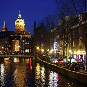 View up the canal in Oudezijds Voorburgwal at night in Amsterdam, Holland