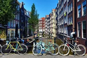 Amsterdam Collection: Bicycles on a bridge on the Oudezijds Achterburgwal canal and houses in Amsterdam