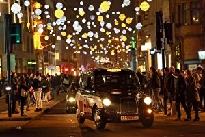 Images Dated 1st November 2015: Black taxi cab and Oxford Street Christmas lights in London