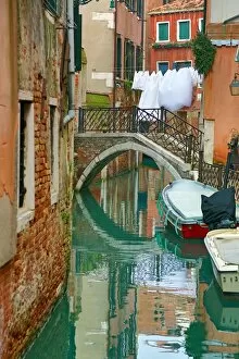 Venice Collection: Bridge over a canal and washing in Venice, Italy