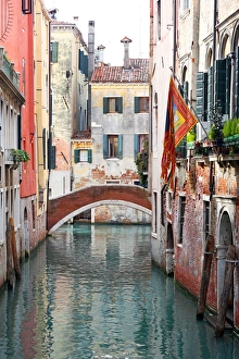 Buildings along a canal with a bridge in Venice, Italy