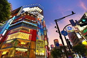 Buildings at sunset at the pedestrian crossing at the intersection in Shibuya, Tokyo Buildings at sunset at the pedestrian crossing at the intersection in Shibuya, Tokyo