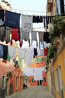 Clothes hanging on a washing line across a street on washday in Venice, Italy Clothes hanging on a washing line across a street on washday in Venice, Italy