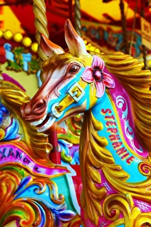 Colourful painted horses on a fairground carousel
