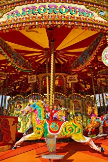 Colourful painted horses on a fairground carousel