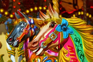 Colourful painted horses on a fairground carousel