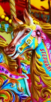 Colourful painted horses on a fairground carousel