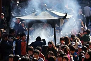 Images Dated 31st January 2014: Crowds of people burning incense at the Shinto Shrine at Senso-Ji Bhuddist Temple in Asakusa in