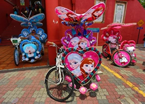 Decorated kitsch cycle trishaw rickshaw with soft toys in Malacca, Malaysia Decorated kitsch cycle trishaw rickshaw with soft toys in Malacca, Malaysia