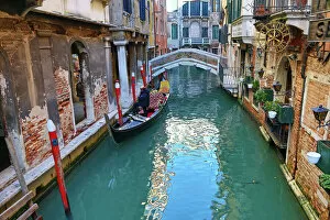 Venice Collection: Deserted bridge over a canal with a gondola in Venice, Italy
